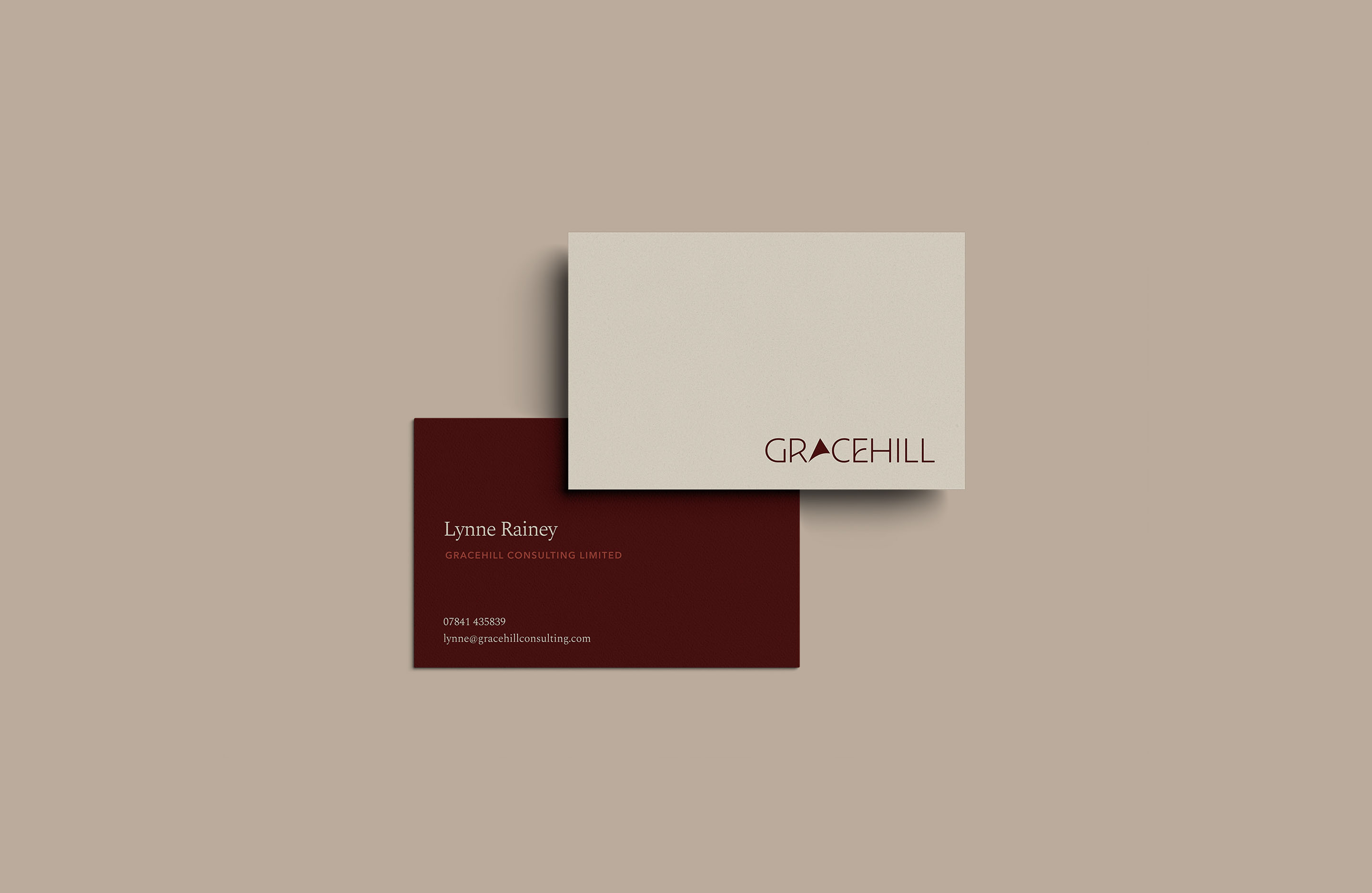 Gracehill Consulting business cards in oxblood and warm neutral colours.