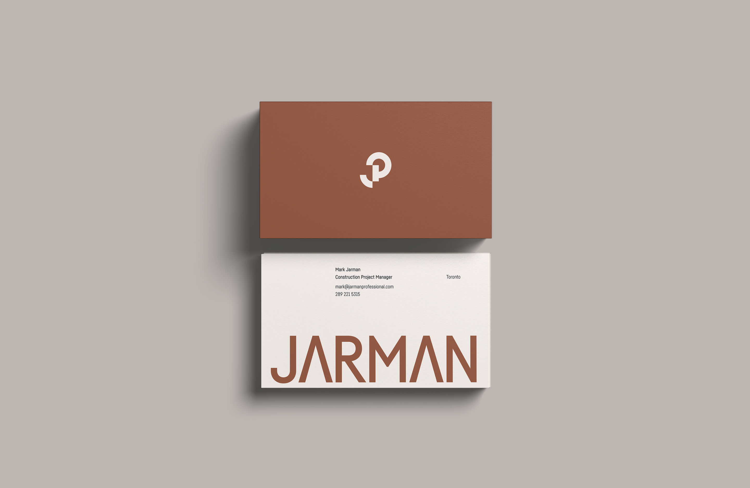 Jarman Professional business cards featuring the JP monogram and rust brand colour.