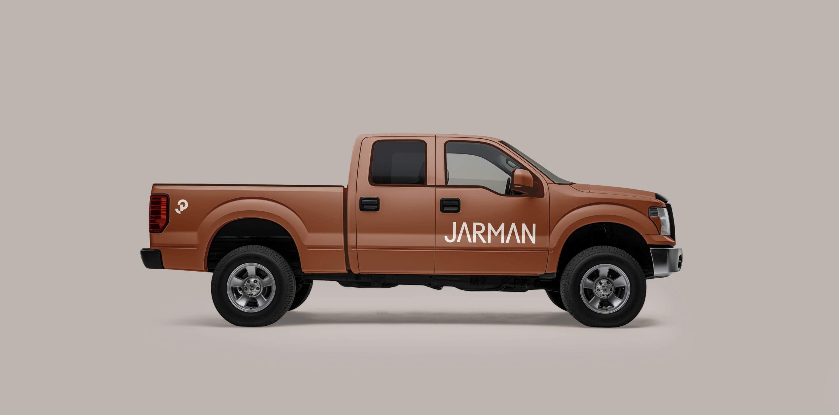 Jarman Professional branding applied to a rust-coloured pickup truck.
