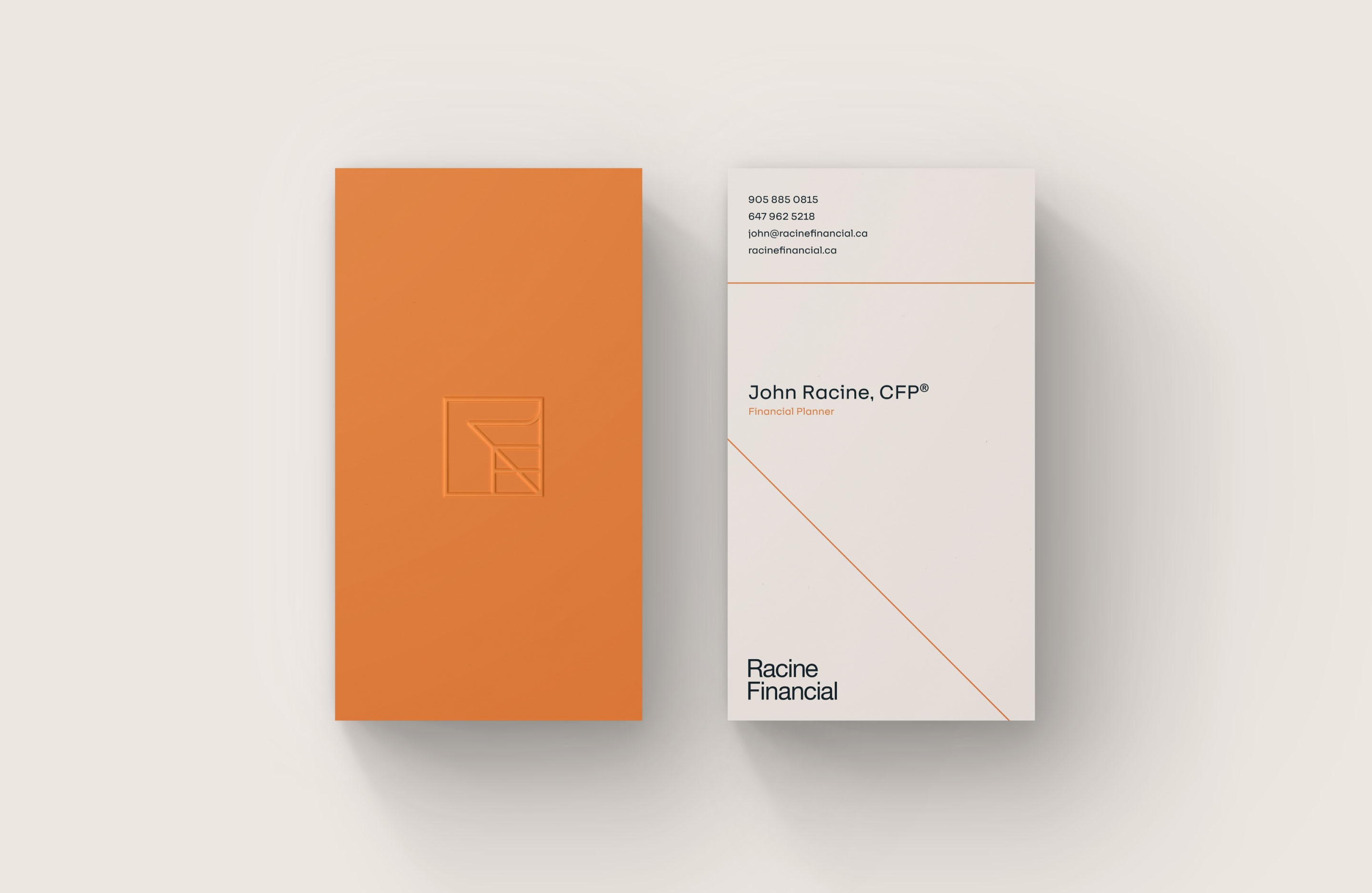 Racine Financial business cards featuring orange, white and embossed brand elements.